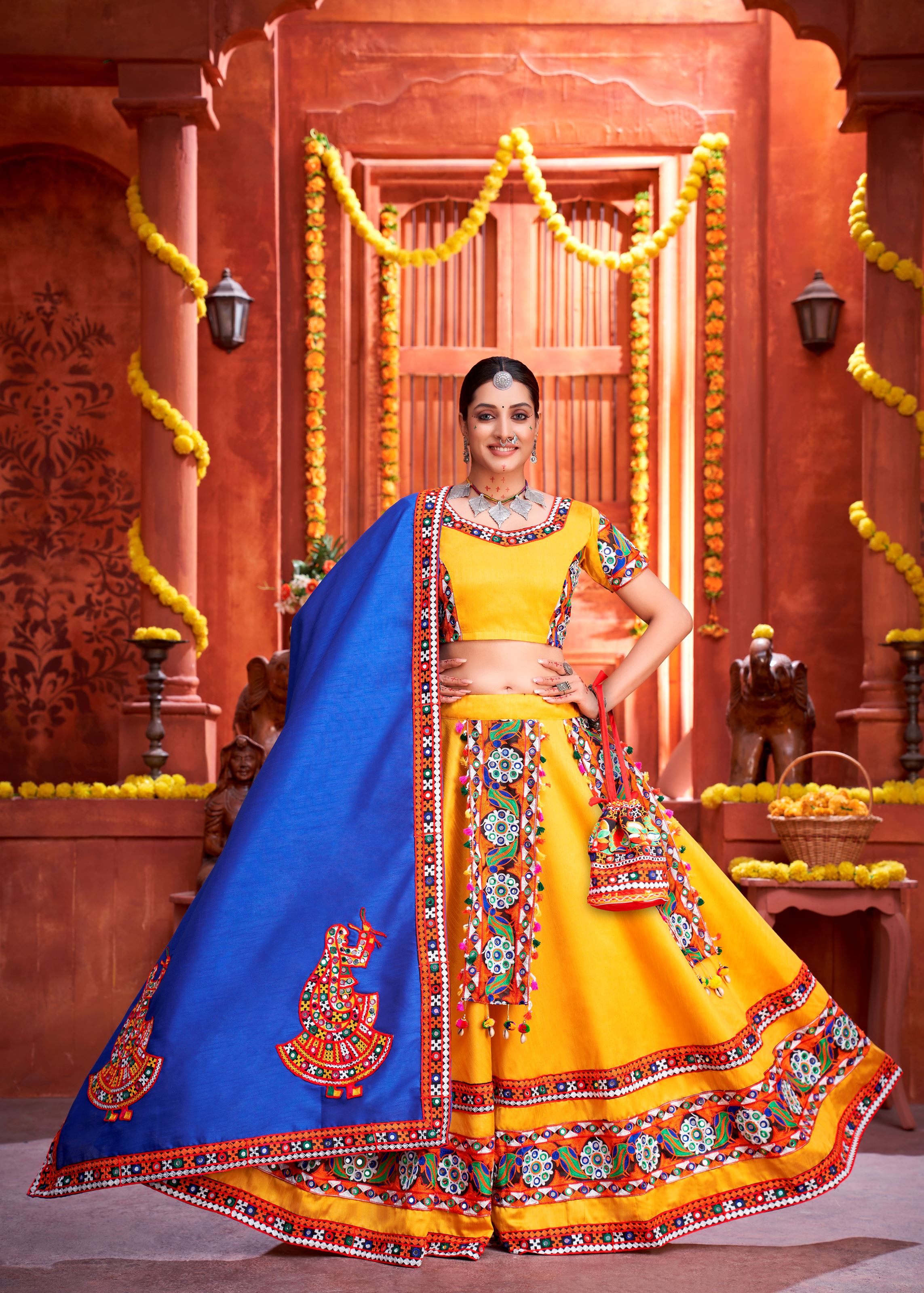 Yellow And Royal Blue Navratri Chaniya Choli With Gamthi Work Butta And Lace With Mirror Hand Work