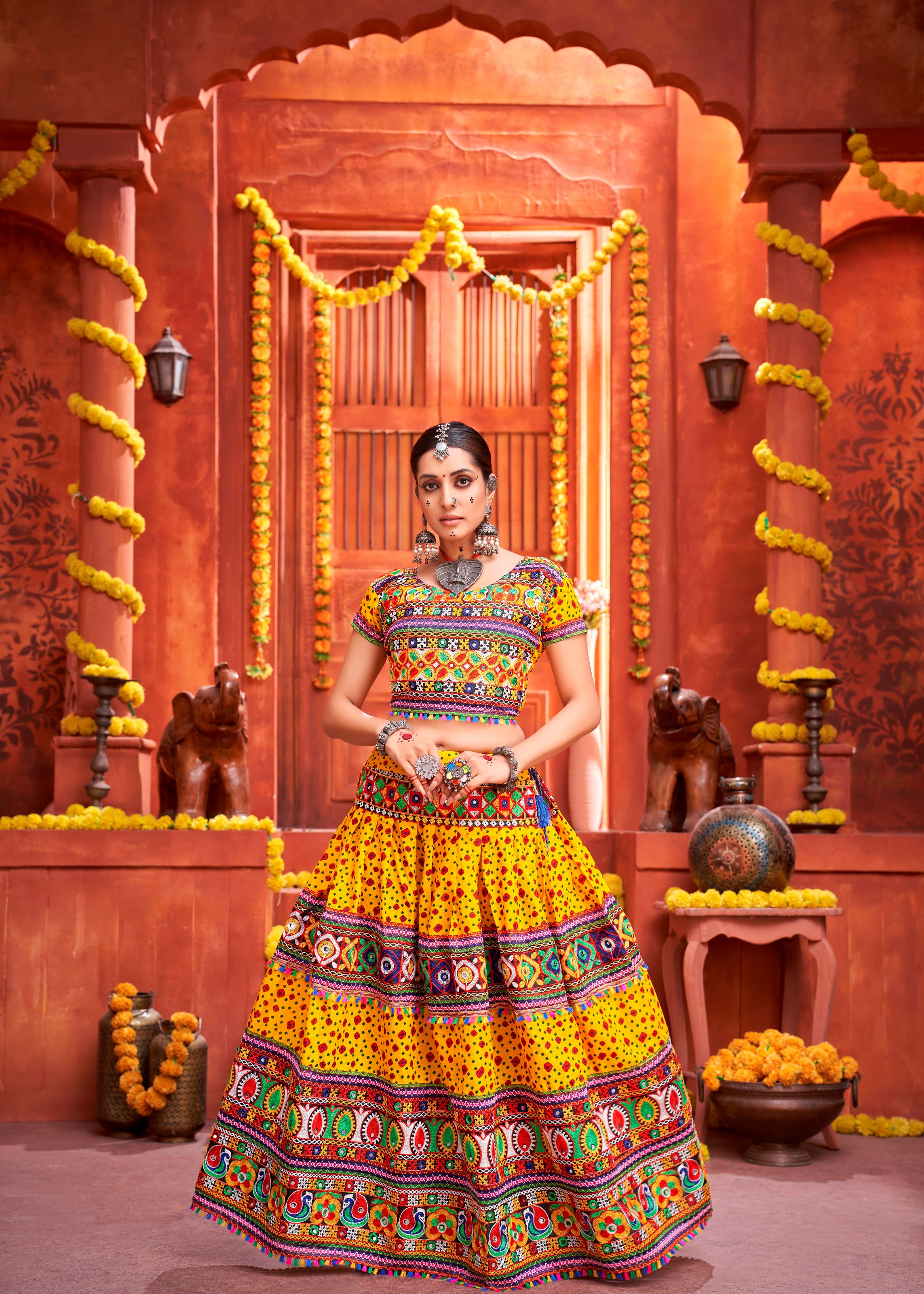 Yellow And Black Navratri Chaniya Choli With Patola Print And Gamthi Work And Real Mirror Work