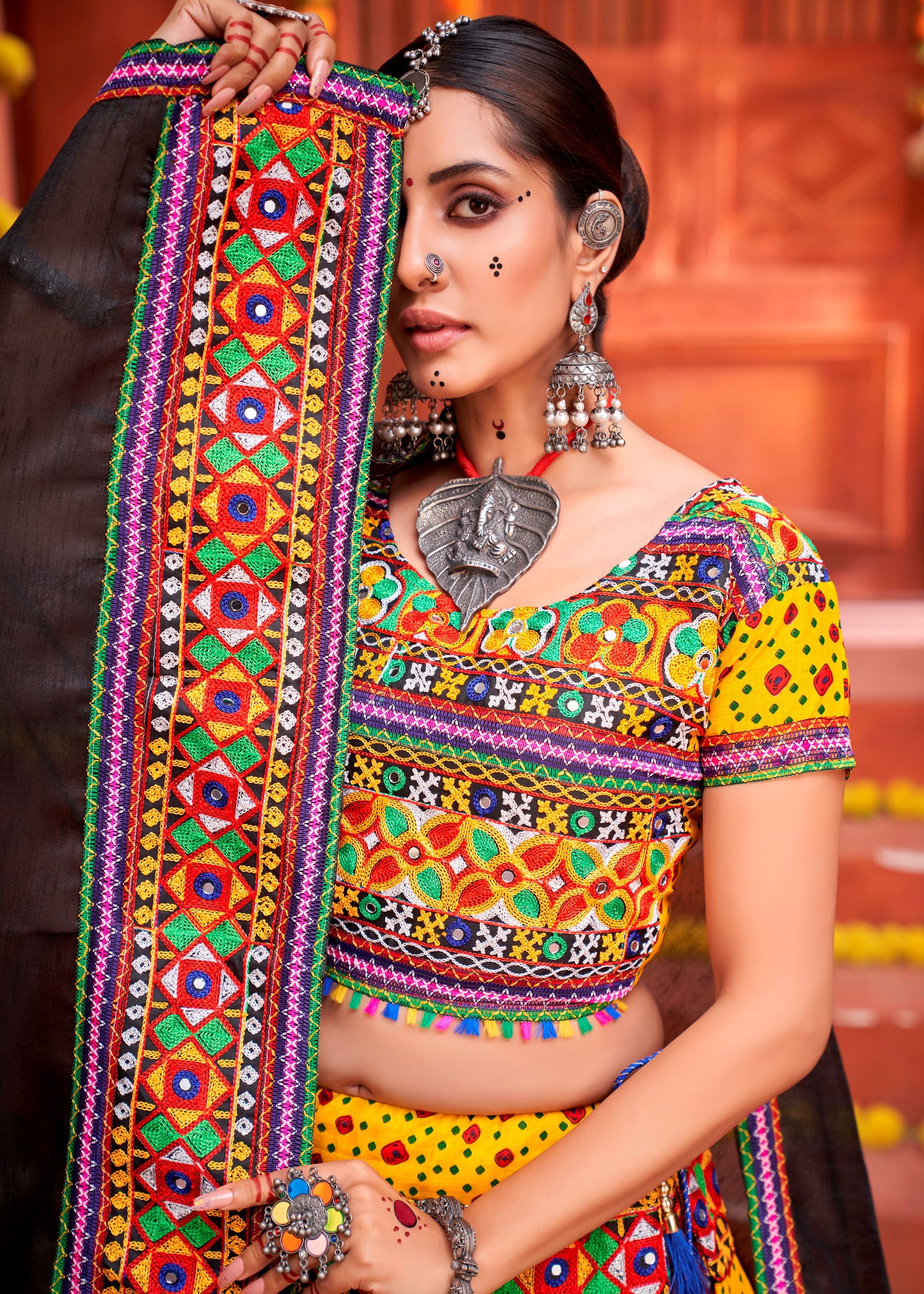 Yellow And Black Navratri Chaniya Choli With Patola Print And Gamthi Work And Real Mirror Work
