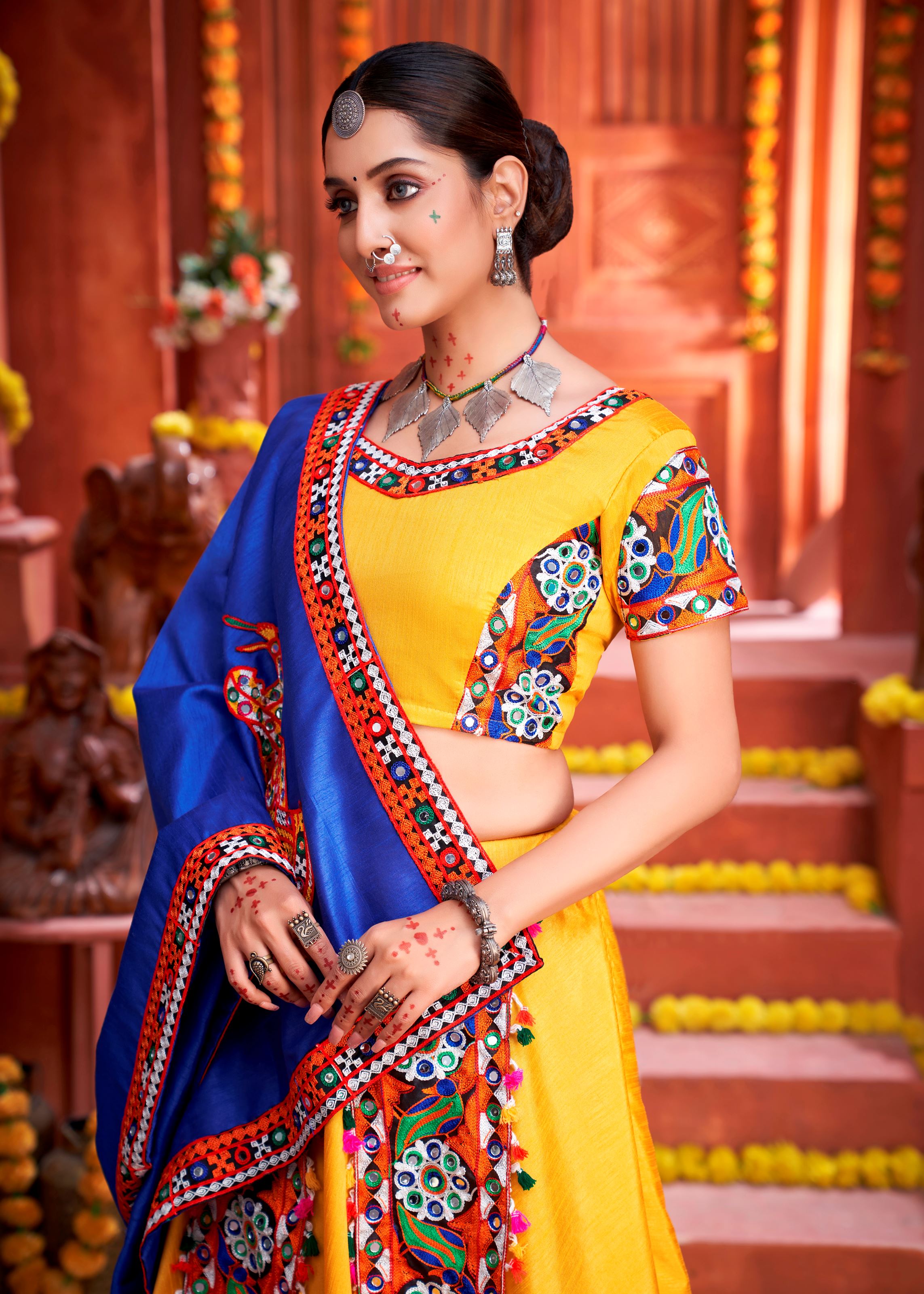Yellow And Royal Blue Navratri Chaniya Choli With Gamthi Work Butta And Lace With Mirror Hand Work