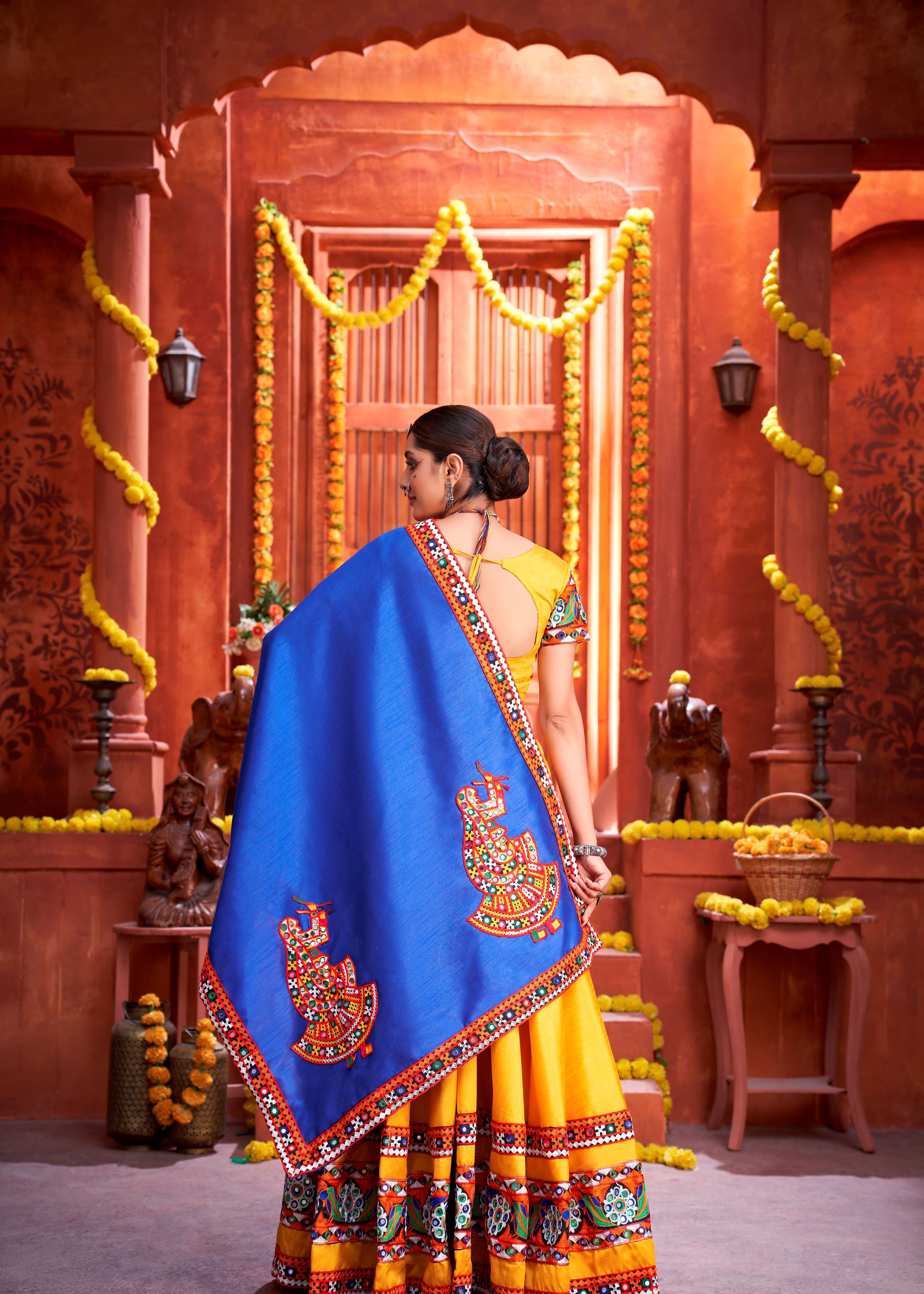 Yellow And Royal Blue Navratri Chaniya Choli With Gamthi Work Butta And Lace With Mirror Hand Work