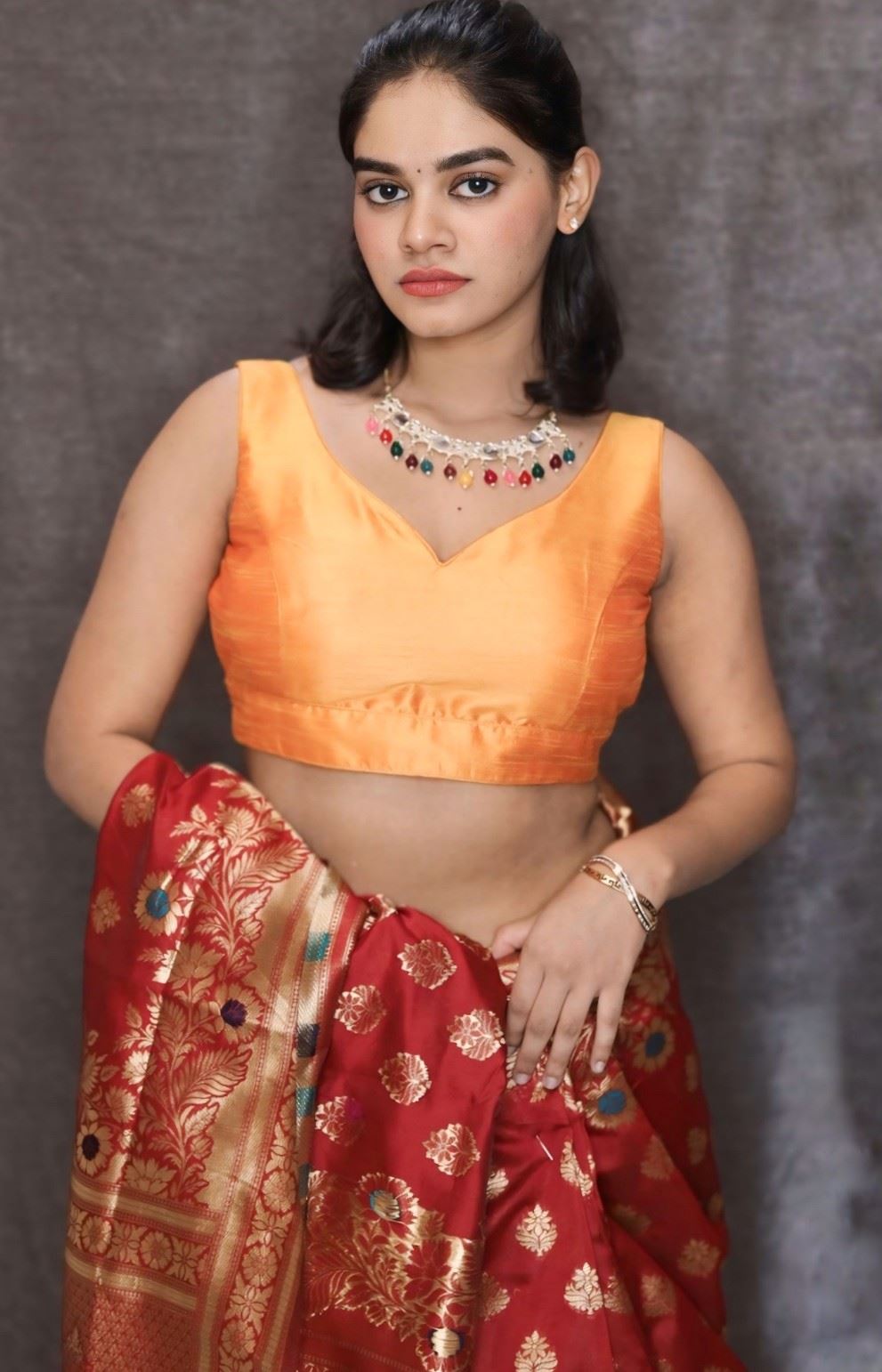 Orange Art Silk Blouse with V-Neckline & Back Bow Detail.