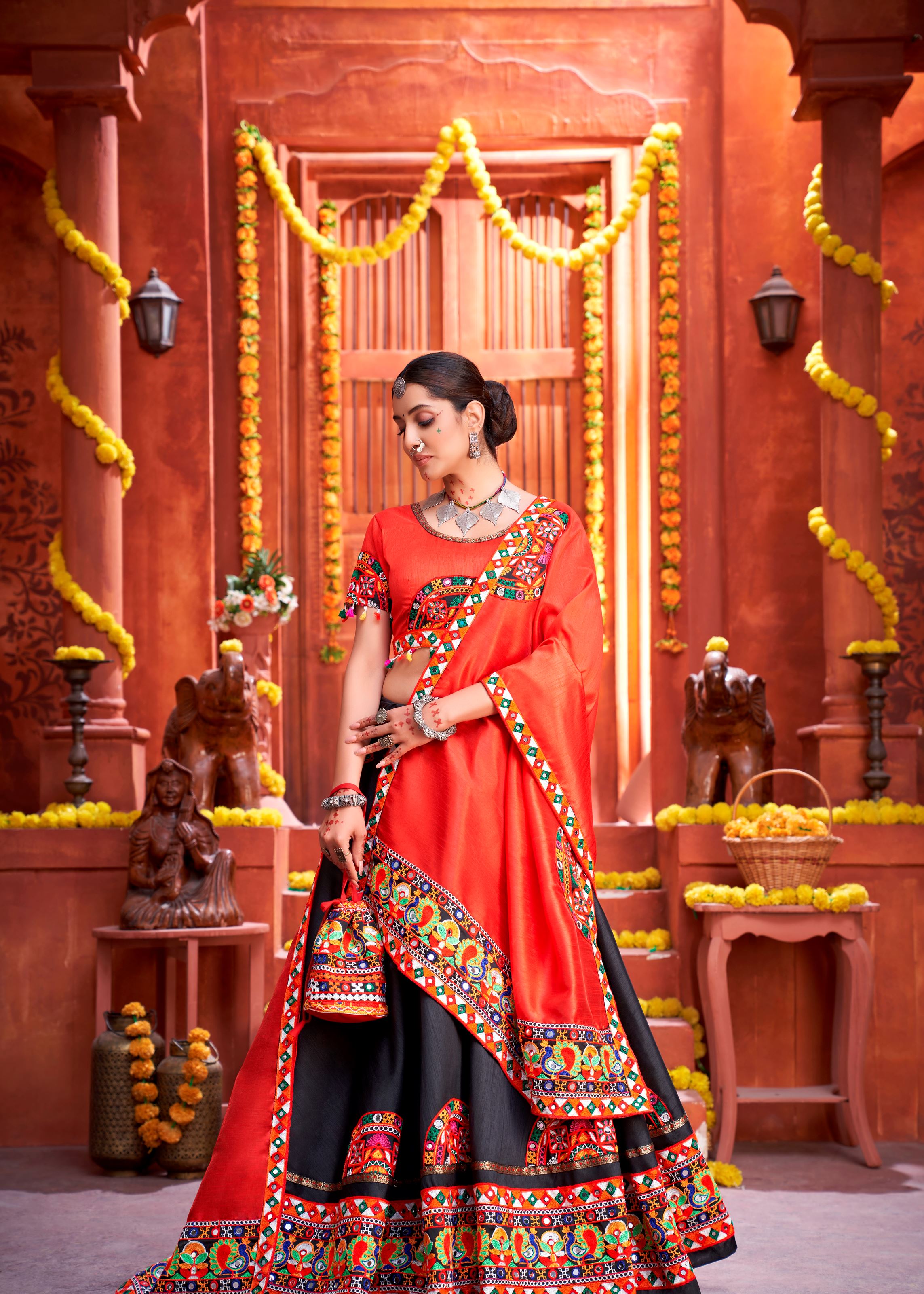 Black And Orange Navratri Chaniya Choli With Gamthi Work Butta And Lace With Mirror Hand Work