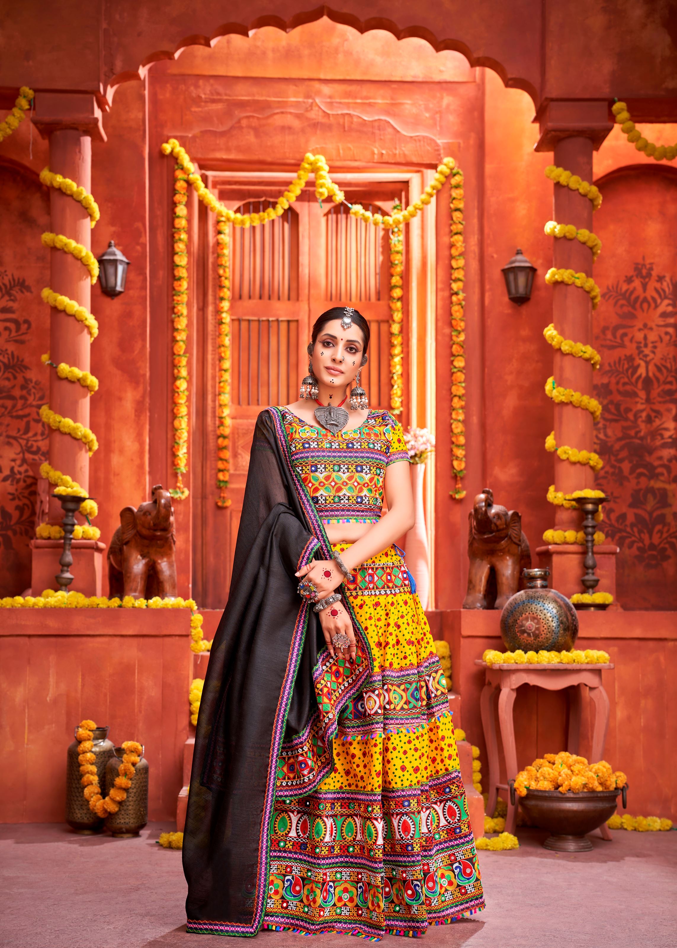 Yellow And Black Navratri Chaniya Choli With Patola Print And Gamthi Work And Real Mirror  Work