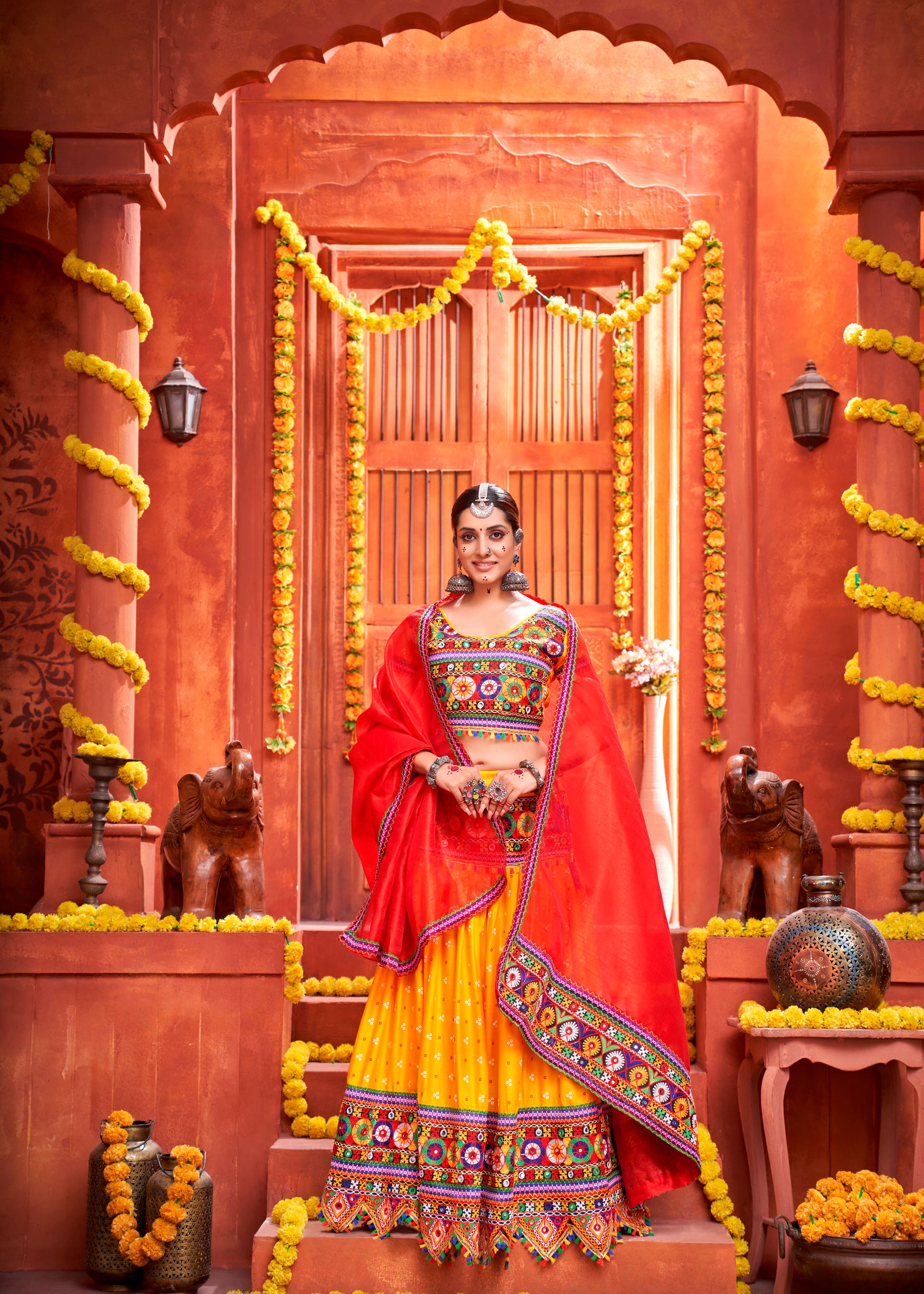 Yellow And Red Navratri Chaniya Choli With Patola Print With Gamthi Work And Real Mirror Work