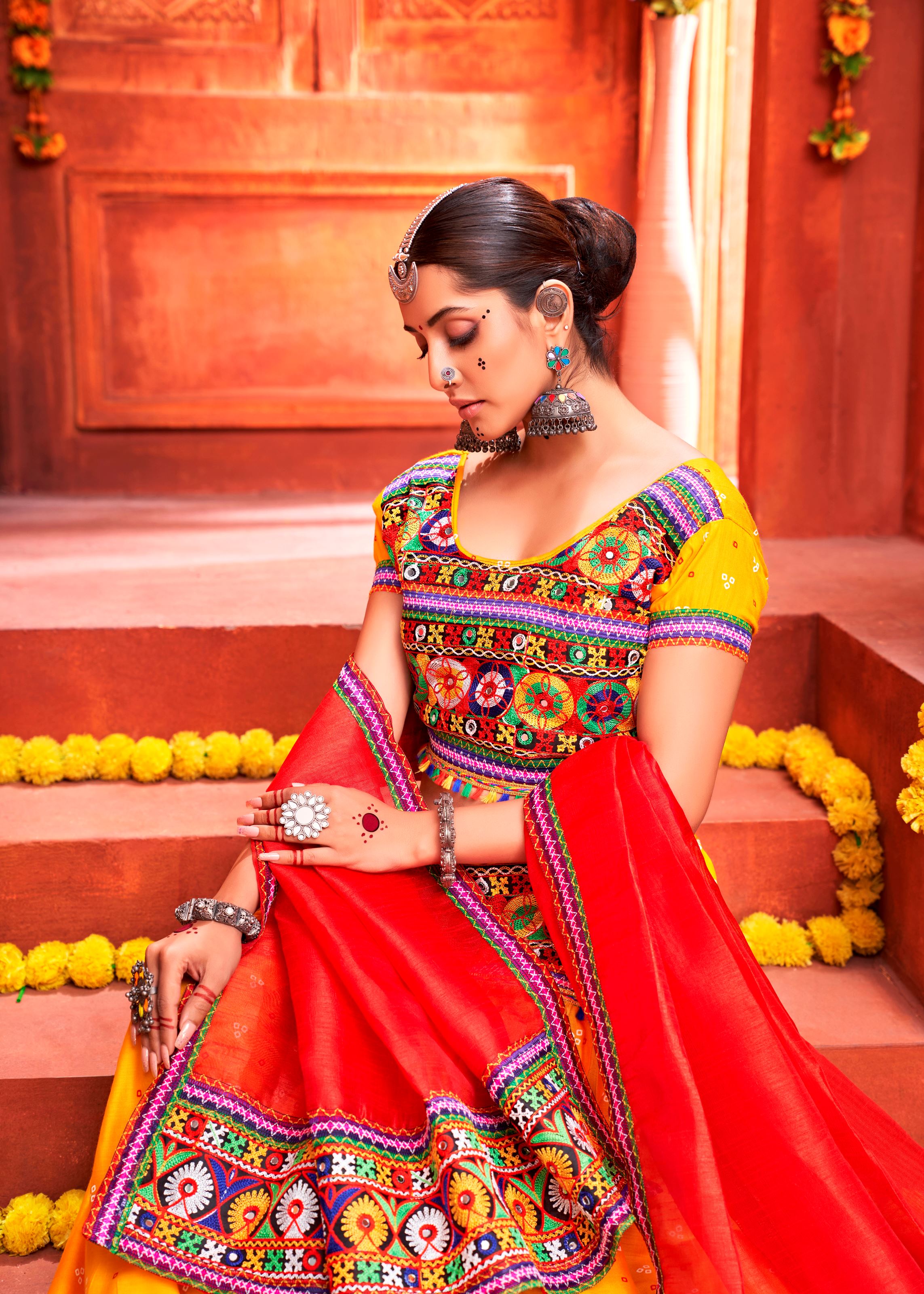 Yellow And Red Navratri Chaniya Choli With Patola Print With Gamthi Work And Real Mirror Work