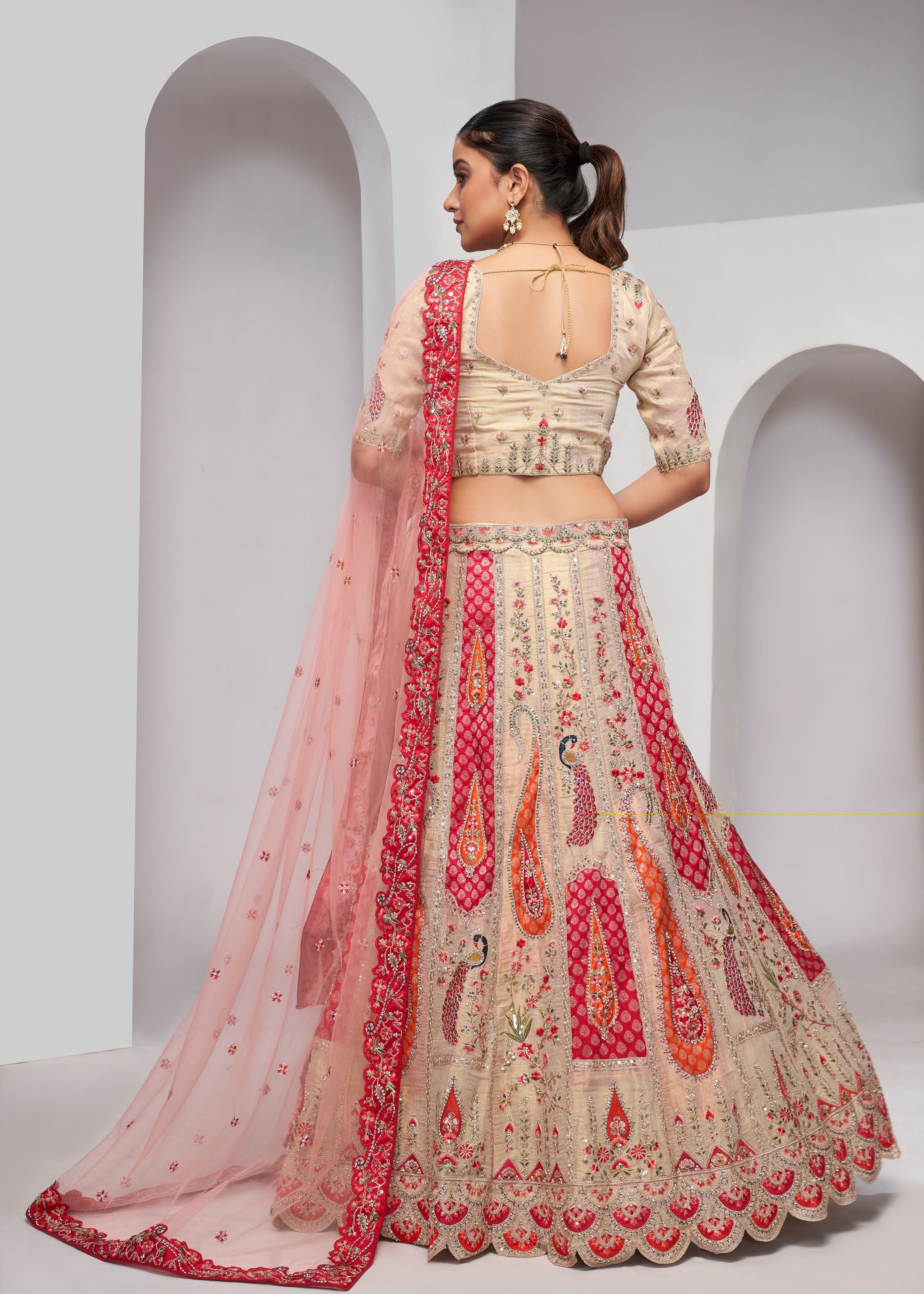 Chiku Banarasi Silk Lehenga Choli With Paisely Motifs Beautiful Peacock Embroidered In Bright Cream Colour