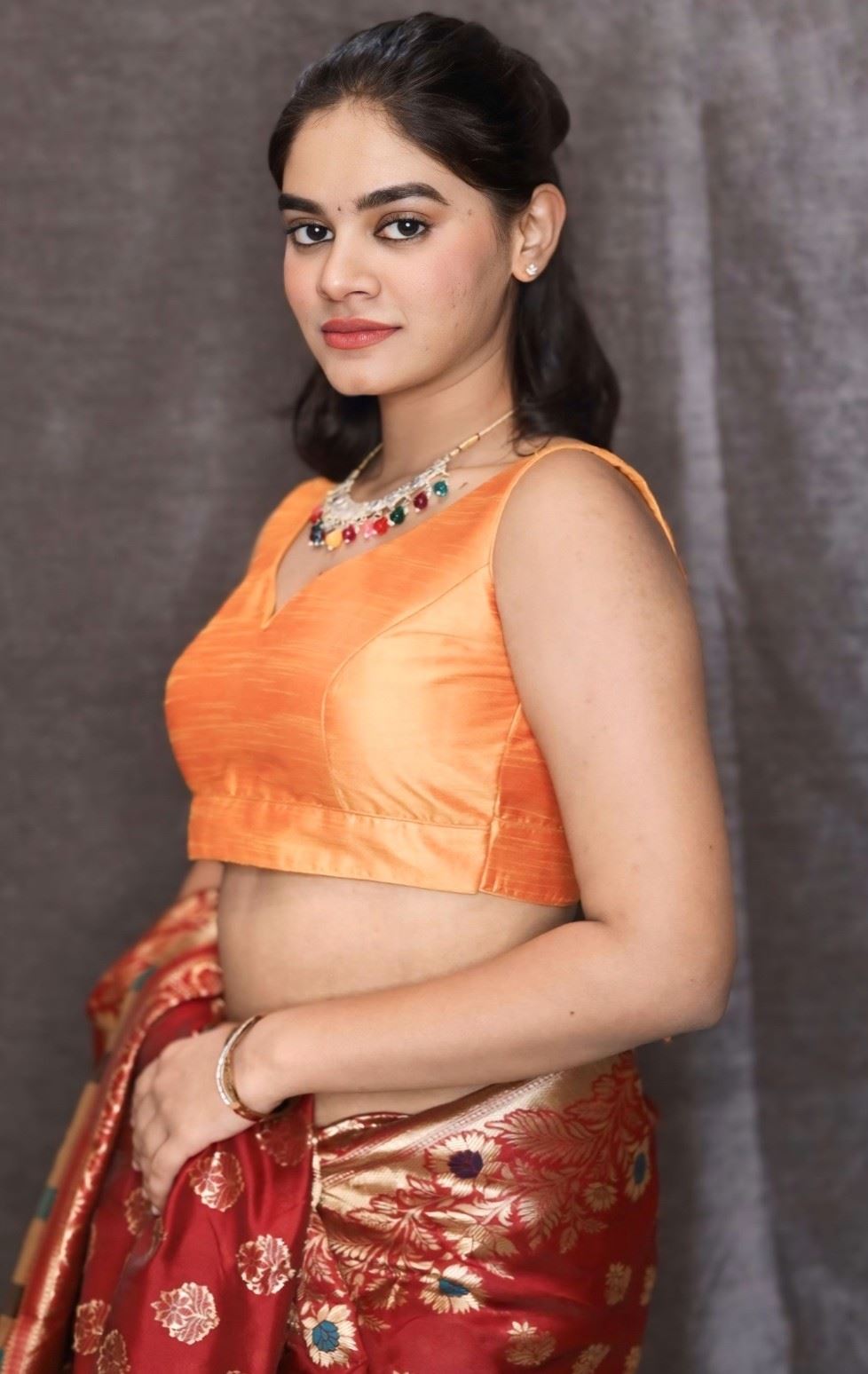 Orange Art Silk Blouse with V-Neckline & Back Bow Detail.