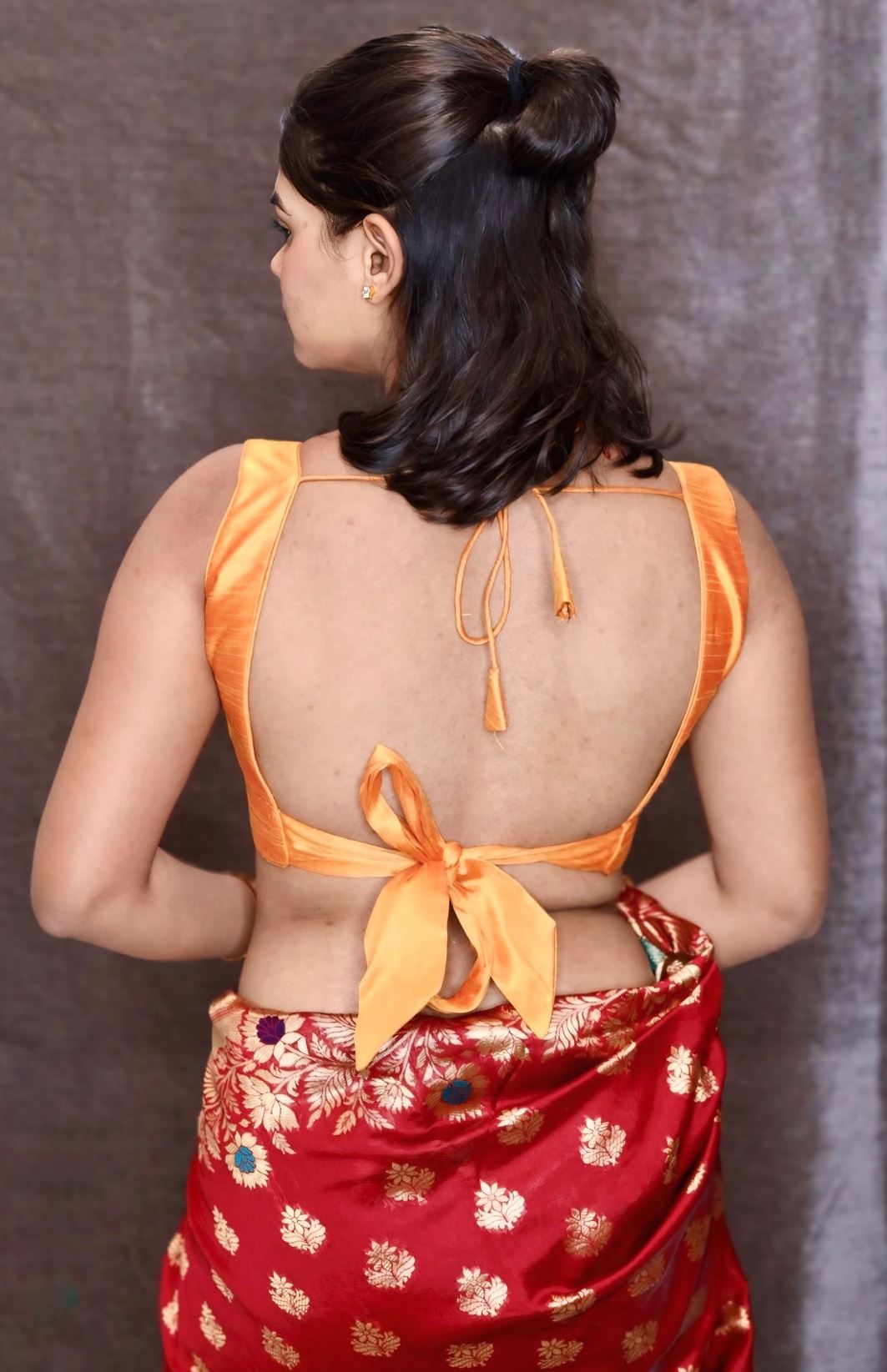 Orange Art Silk Blouse with V-Neckline & Back Bow Detail.